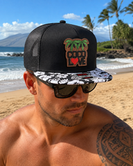 Coco Love cork patch trucker hat with hibiscus brim worn at the beach