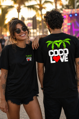 Woman wearing Coco Love black tee with left-chest palm logo on the boardwalk