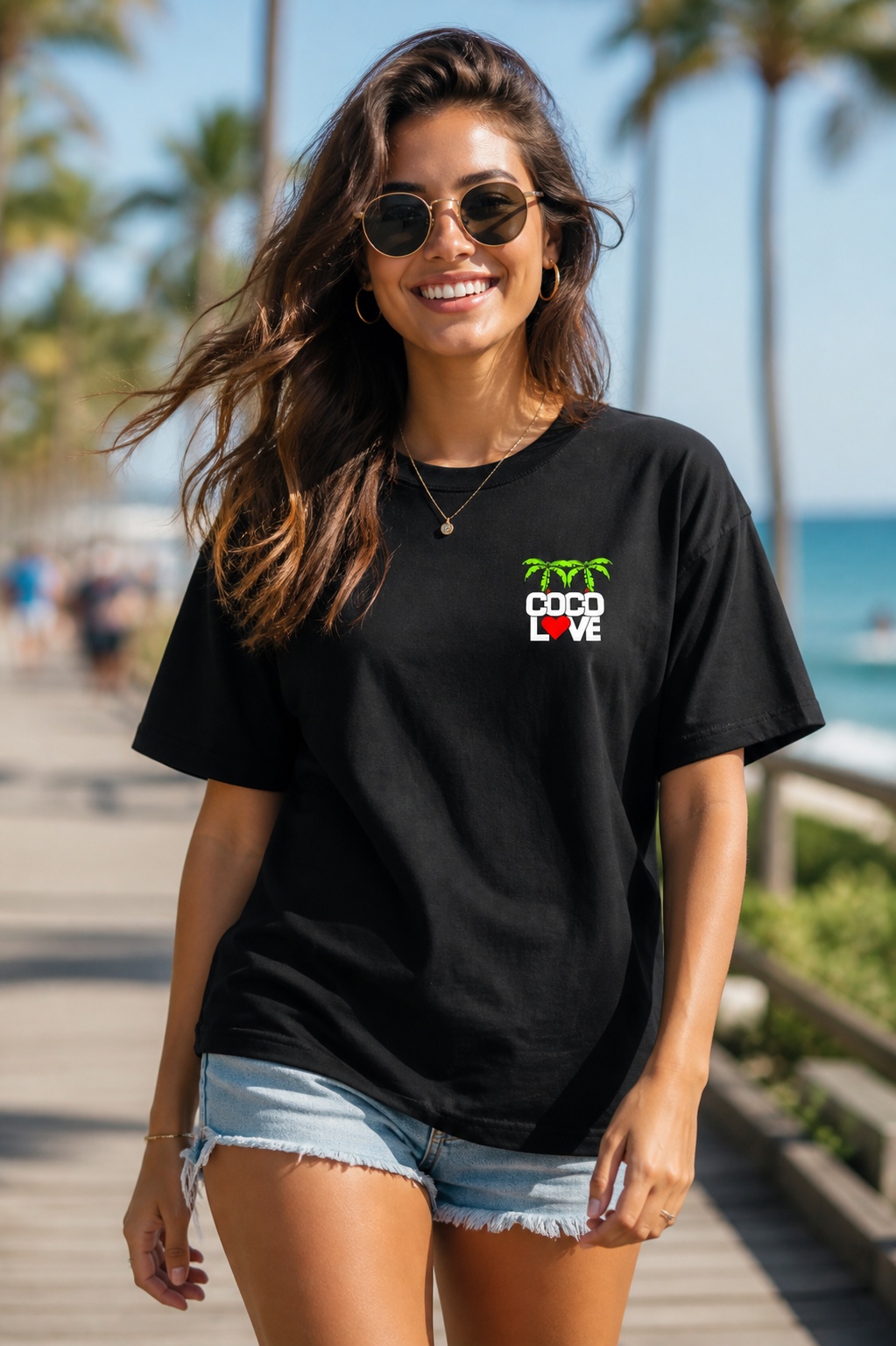 Man wearing Coco Love black tee with palm and heart chest logo